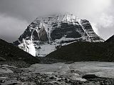 Tibet Kailash 08 Kora 25 North Face The weather had cleared and the north face was fairly visible, so I decided to take a walk towards the north face between the hills called Avalokiteshvara and Vajrapani. I crested the hill behind the guesthouse, and noticed a monk and two other people continuing to walk towards the north face. I followed them along the Kangjam Chu and crossed the snout of the glacier with Kailash looking fantastic. I continued on, cresting a small hill with a clear view of the Kangjam Glacier descending from the north face of Mount Kailash. The monk asked me to take their photos. Coming back only took 15 minutes.